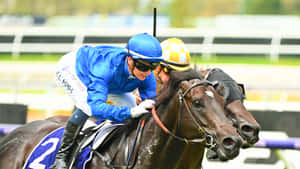 Jamie Kah Majestically Rides A Racehorse On The Track Wallpaper