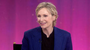 Jane Lynch Purple Background Talk Show Wallpaper