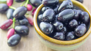 Java Plums In A Ceramic Bowl Wallpaper