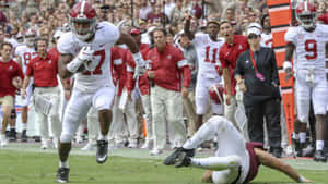 Jaylen Waddle Evading Tackle During Game Wallpaper