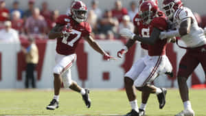 Jaylen Waddle In Action During College Football Game Wallpaper