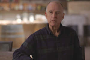 Jerry Brown Sitting In A Chair Wallpaper