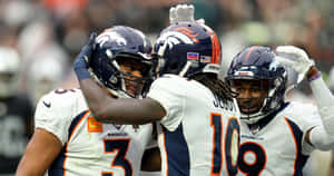 Jerry Jeudy Celebrationwith Denver Broncos Teammates Wallpaper