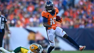 Jerry Jeudy Evading Tackle During Game Wallpaper