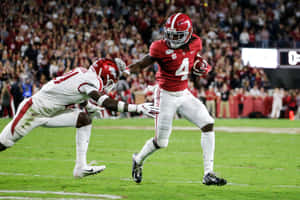 Jerry Jeudy Evading Tackle During Game Wallpaper