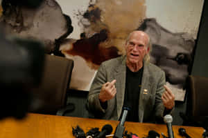 Jesse Ventura Speaking At A Media Event Wallpaper