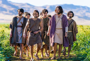 Jesus And His Disciples Share A Spiritual Moment Wallpaper