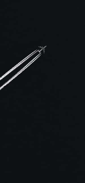 Jet_ Contrail_ Against_ Dark_ Sky Wallpaper
