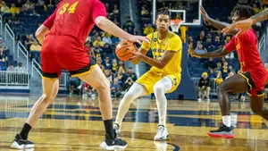 Jett Howard Performs A Powerful Slam Dunk Wallpaper