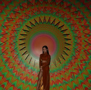 Jhene Aiko Posing Artistically In Colorful Dress Wallpaper