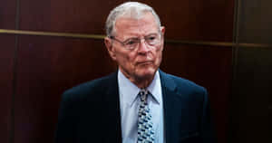 Jim Inhofe With Wooden Wall Background Wallpaper