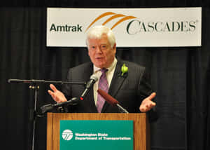 Jim Mcdermott Standing On Podium Wallpaper