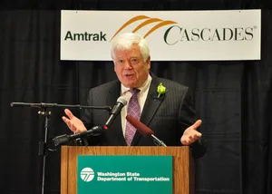 Jim Mcdermott Standing On Podium Wallpaper