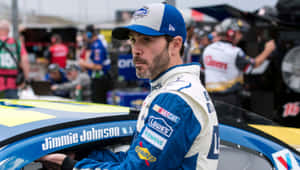 Jimmie Johnson Racing On The Track In His Iconic Car Wallpaper