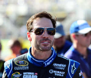 Jimmie Johnson Racing On The Tracks In His No. 48 Car Wallpaper