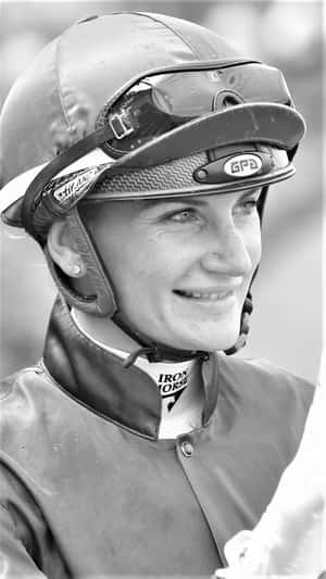 Jockey Champion Jamie Kah Posing At The Racetrack Wallpaper