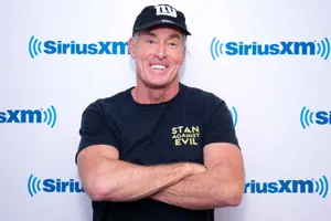 John C. Mcginley Smiling In A Relaxed Pose Wallpaper