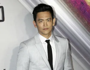 John Cho Smiles For The Camera At An Event Wallpaper