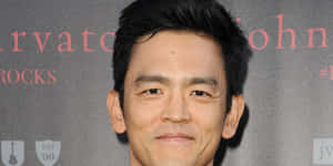 John Cho Striking A Pose At A Photoshoot. Wallpaper