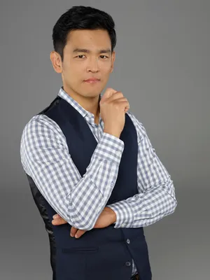 John Cho Striking A Pose During A Photoshoot Wallpaper