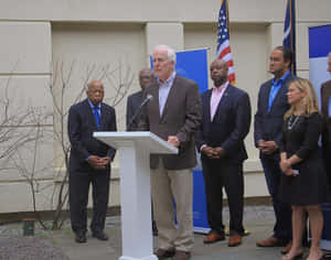 John Cornyn Speaking On A Podium Wallpaper