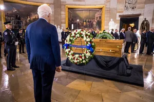 John Cornyn Standing Before A Casket Wallpaper