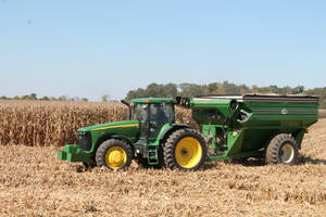 John Deere Tractor In Harvesting Wheat Wallpaper