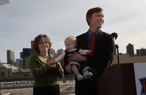 John Hickenlooper Holding A Baby Wallpaper