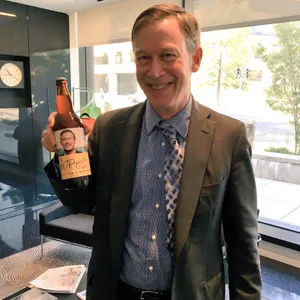 John Hickenlooper Holding A Bottle Of Beer Wallpaper