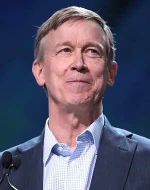 John Hickenlooper Smiling In A Dark Blue Suit Wallpaper