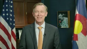 John Hickenlooper Standing In Front Of American Flag Wallpaper