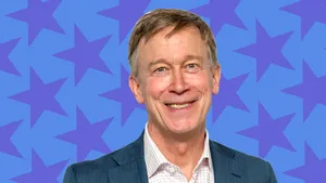 John Hickenlooper With Blue Stars Backdrop Wallpaper