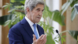John Kerry Posing Near Green Plants Wallpaper
