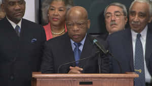 John Lewis Speaking On A Podium Wallpaper