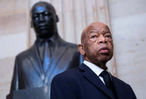 John Lewis Standing Beside Martin Luther King Jr. Statue Wallpaper