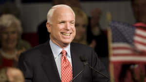 John Mc Cain Smiling During Speech Wallpaper