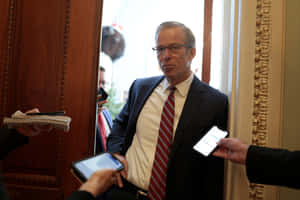 John Thune Leaning On Wall Wallpaper