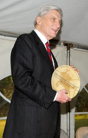 John Warner Holding A Trophy Phone Wallpaper