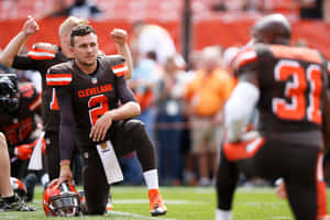 Johnny Manziel Kneelingon Football Field Wallpaper