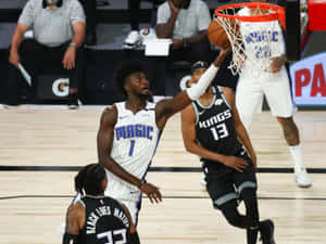 Jonathan Isaac Reaching Basketball Ring Wallpaper