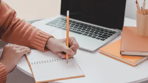 Jotting Down Notes In A Subject Wallpaper