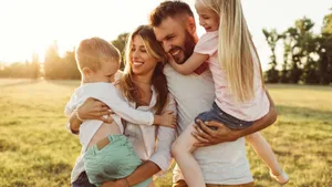 Joyful Family Outdoors Sunset Wallpaper