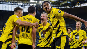 Jude Bellingham Celebrationwith Dortmund Teammates Wallpaper