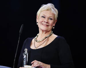Judy Dench With A Trophy Wallpaper