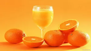 Juice Served With Orange Slices Wallpaper