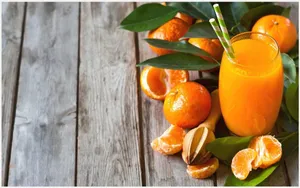 Juice With Orange Fruits And Leaves Wallpaper
