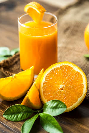 Juice With Orange Wedge And Wheel Slices Wallpaper