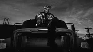 Juice Wrld Sitting On A Car Posthumous Wallpaper