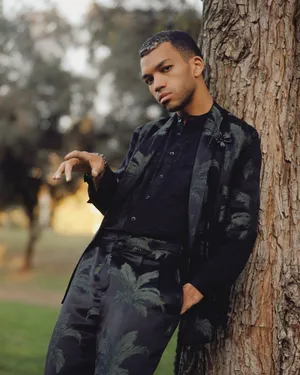 Justice Smith Posing For A Photoshoot Wallpaper