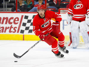 Justin Faulk In Action In Red Uniform Wallpaper